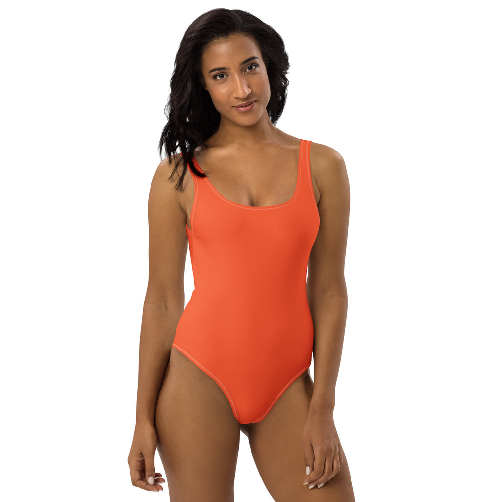 A vibrant orange buttery soft one-piece swimsuit with upf 50 and thin straps for women