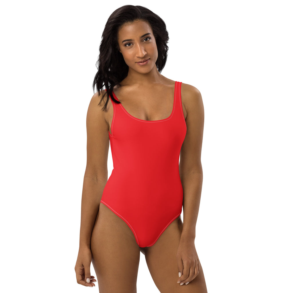 A vibrant red one-piece buttery soft swimsuit with thin straps and UPF 50 plus for sun protection