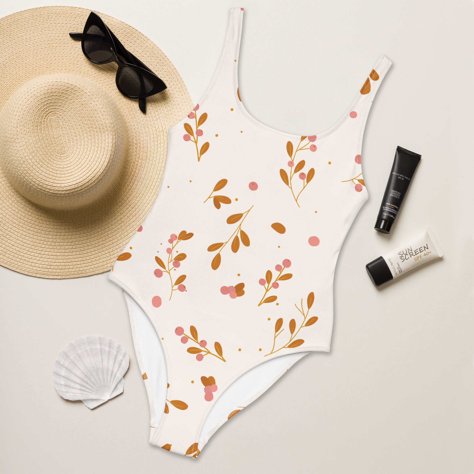 White one-piece minimalist floral swimsuit with delicate brown leaf and pink berry pattern and UPF 50+ protection