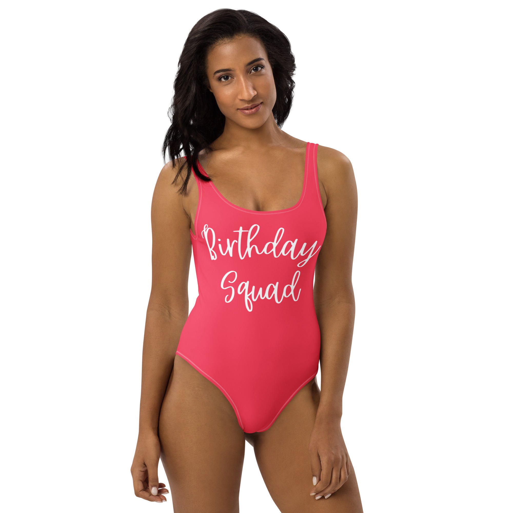 A vibrant pink women’s birthday squad buttery soft swimsuit with white cursive script and UPF 50 plus protection