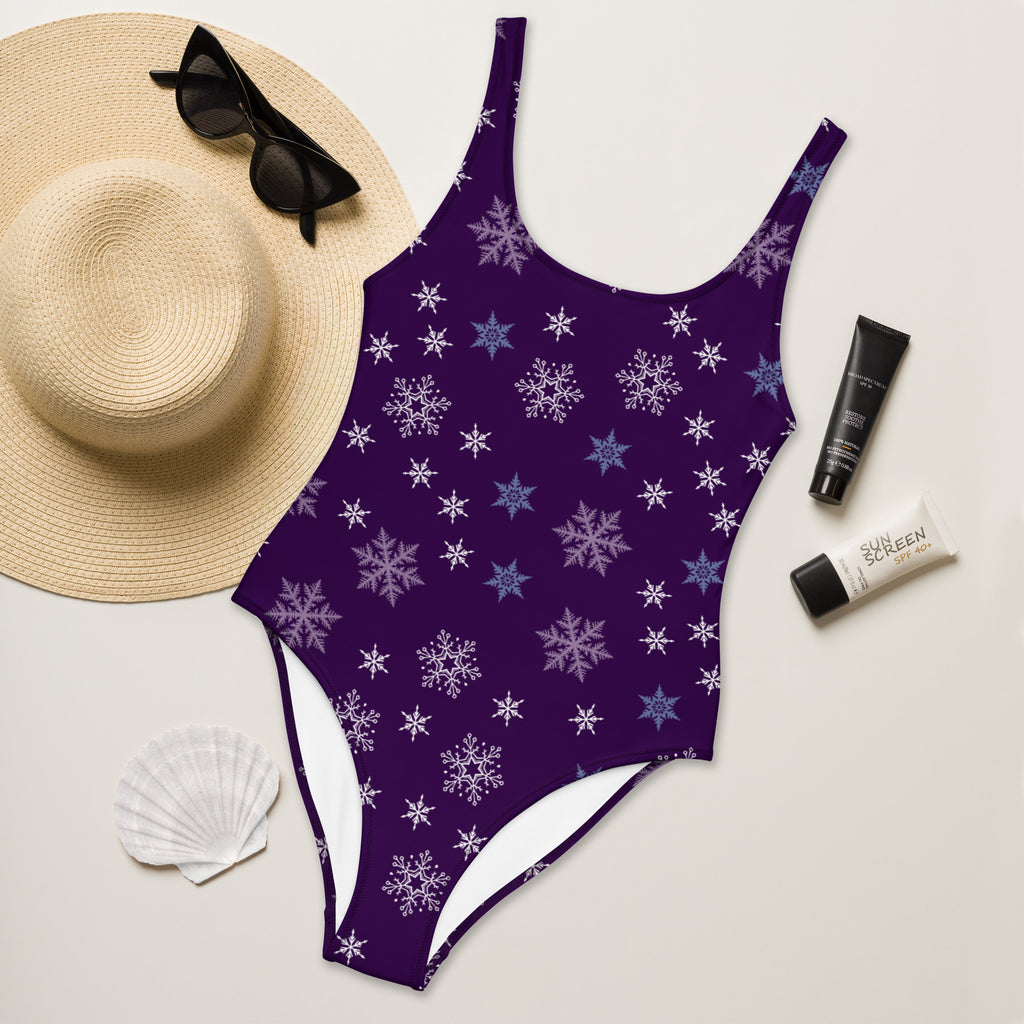 Women’s purple one-piece buttery soft swimsuit with white and light blue snowflake pattern and UPF 50+ protection
