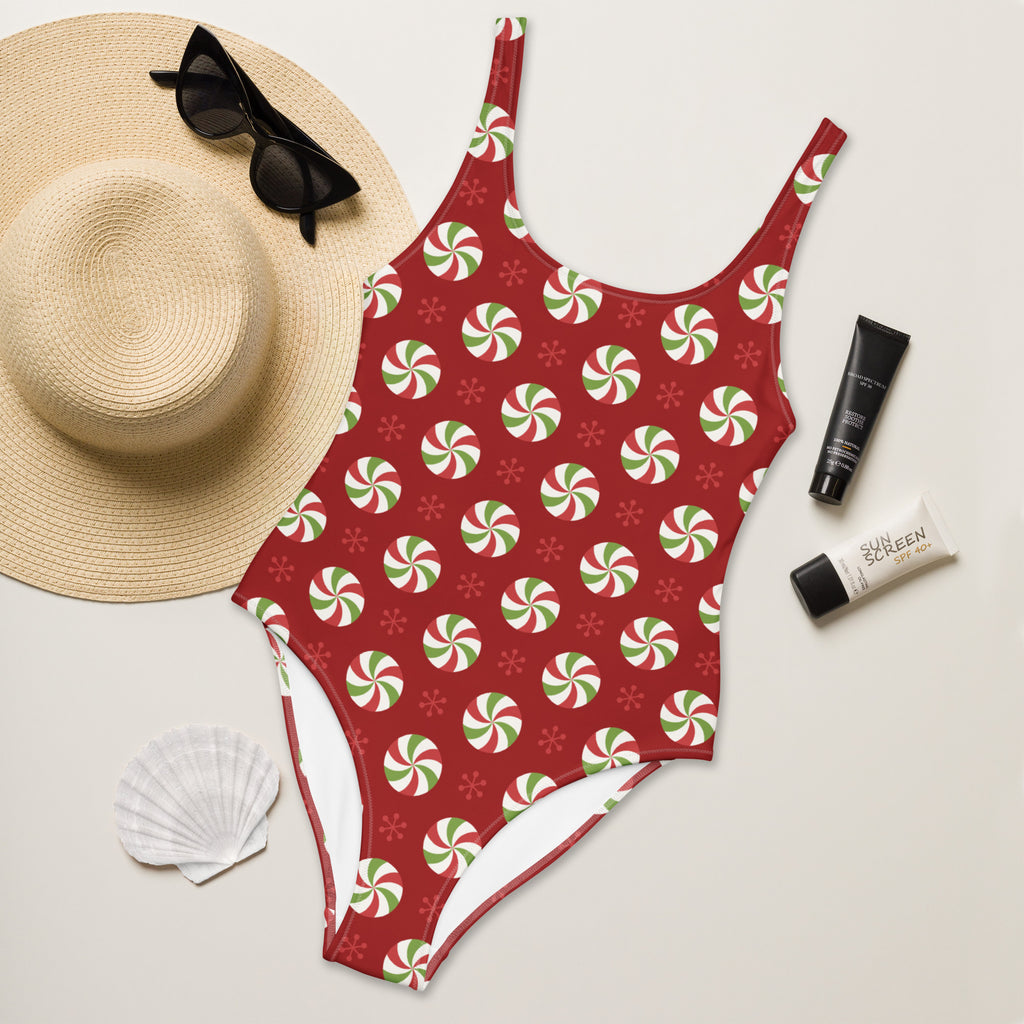 Women’s red one-piece peppermint swirl christmas swimsuit with buttery soft fabric and upf 50+ protection