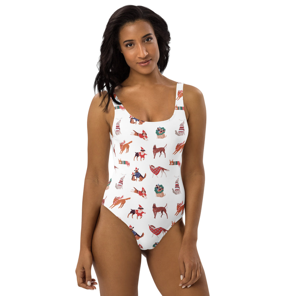 White buttery soft one-piece swimsuit with UPF 50 plus featuring festive cartoon dogs in holiday attire and gifts