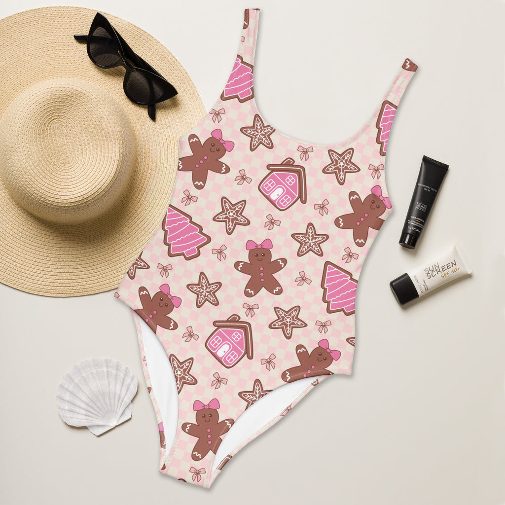 Women’s pink gingerbread christmas buttery soft one-piece swimsuit with festive cookie pattern and UPF 50 plus protection