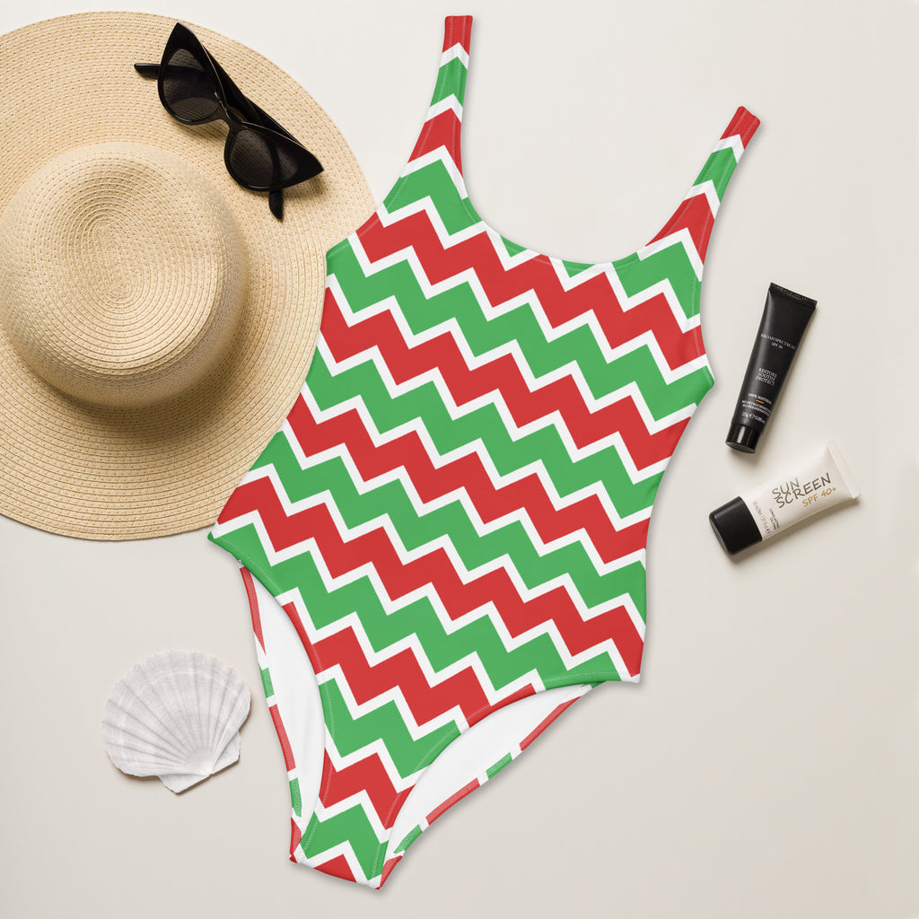 A vibrant red and green zigzag patterned women’s Christmas chevron buttery soft swimsuit with UPF 50+ and white trim