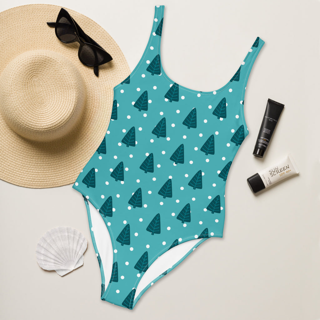 Teal women’s one-piece Christmas tree buttery soft swimsuit with dark green pine trees white polka dots and UPF 50+ protection