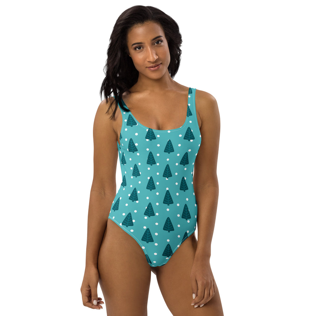 A teal one-piece womens christmas tree buttery soft swimsuit with dark green pine tree pattern and upf 50 plus protection