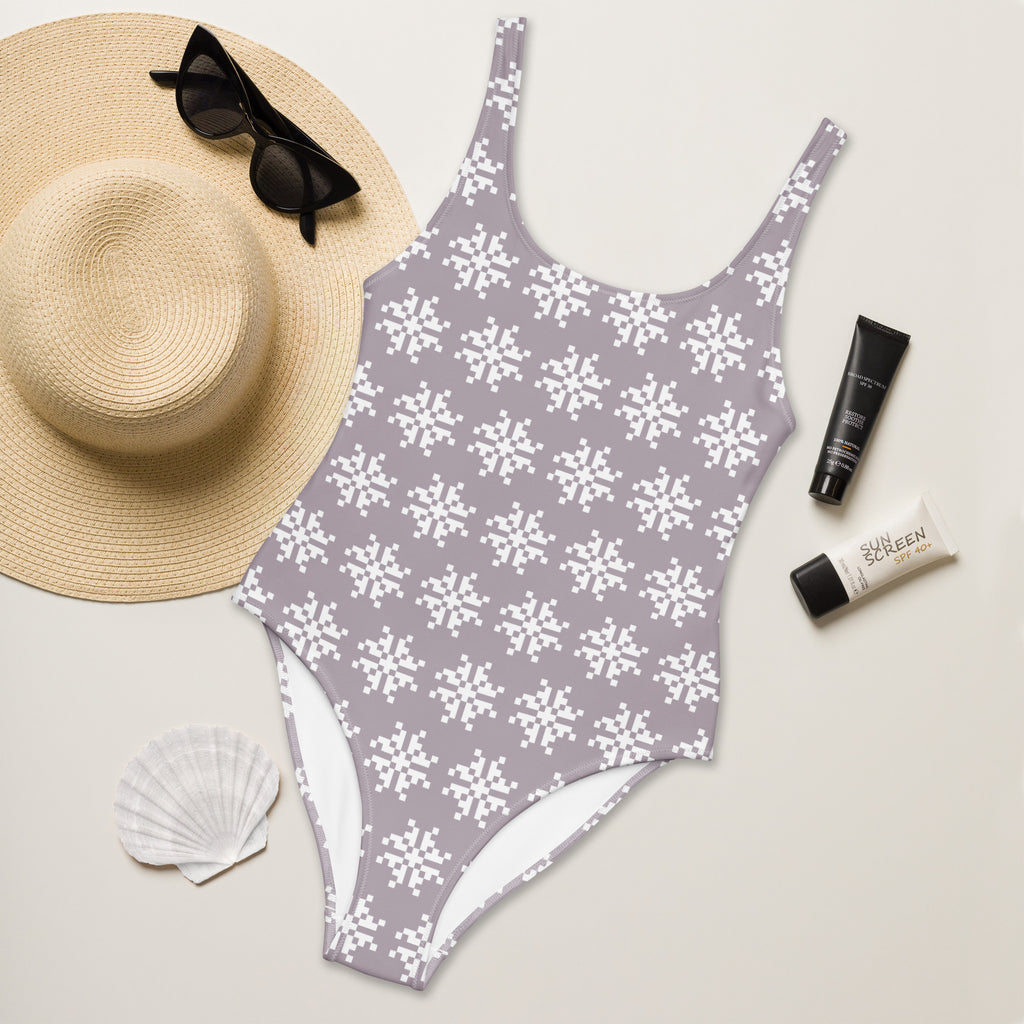 Women’s mauve buttery soft one-piece swimsuit with white pixel snowflake pattern and UPF 50+ protection