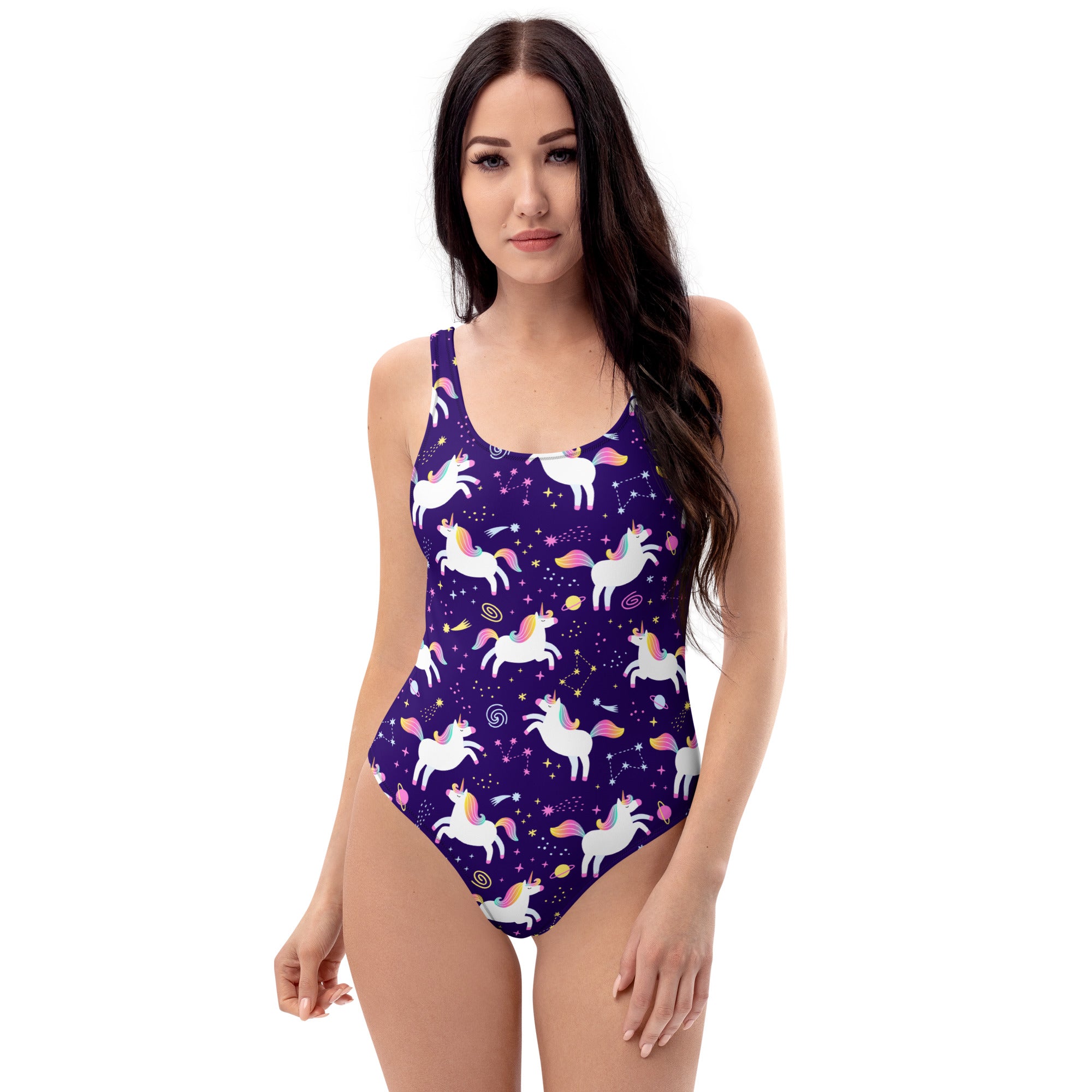 Woman wearing a purple one-piece swimsuit with unicorn pattern on a white background
