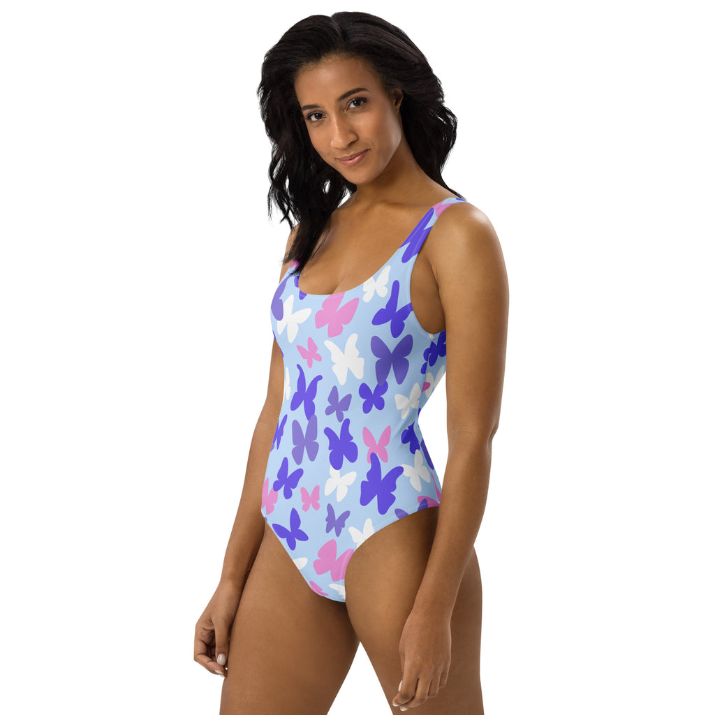A light blue women’s one-piece swimsuit with pink white and purple butterfly pattern buttery soft fabric UPF 50+