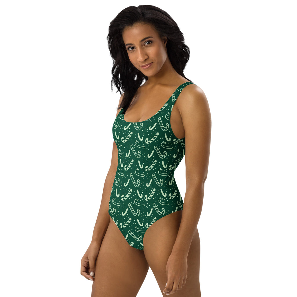 Women’s green candy cane christmas buttery soft one-piece swimsuit with upf 50+ featuring white candy cane pattern