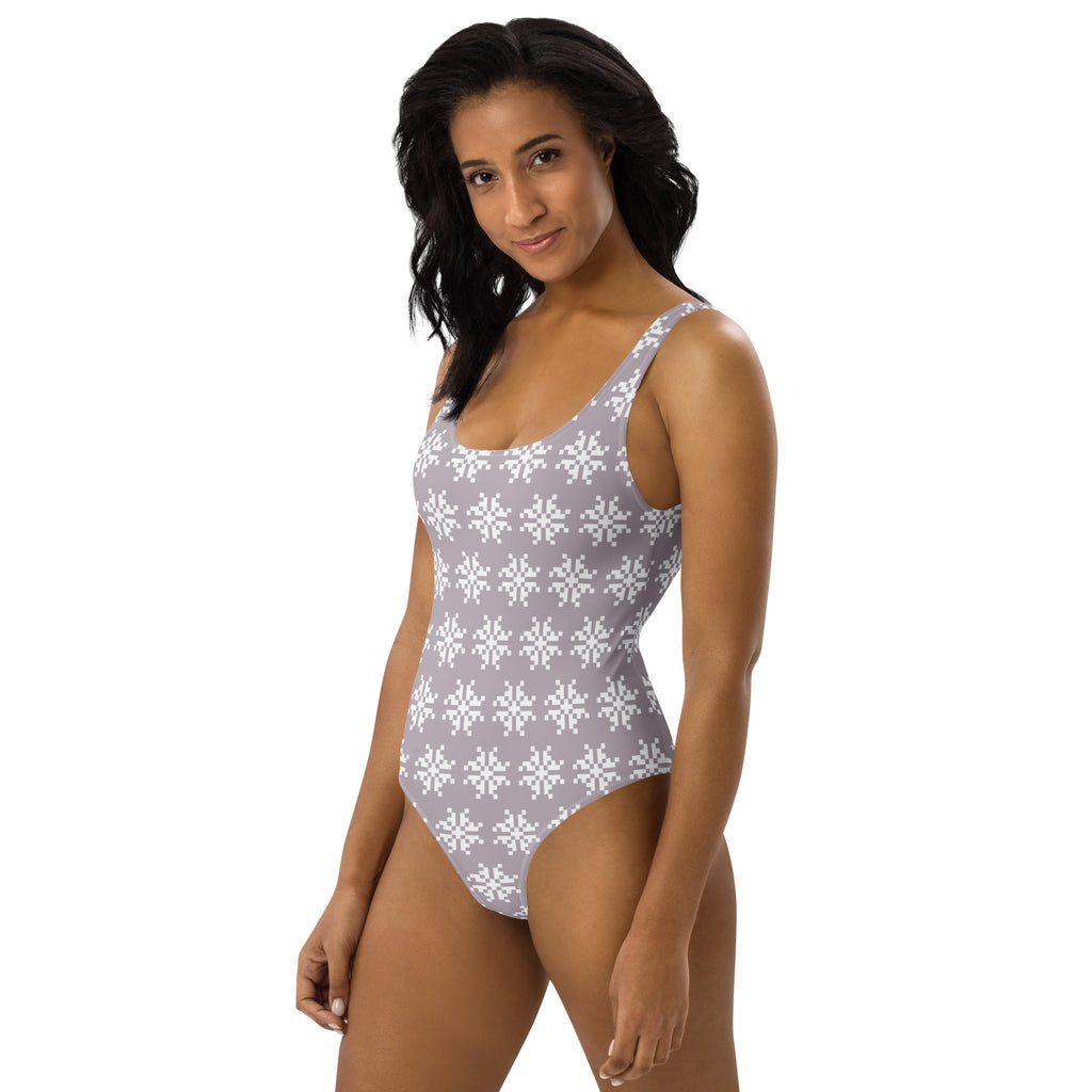 Women’s mauve one-piece buttery soft swimsuit with white pixel snowflake pattern and UPF 50 plus sun protection