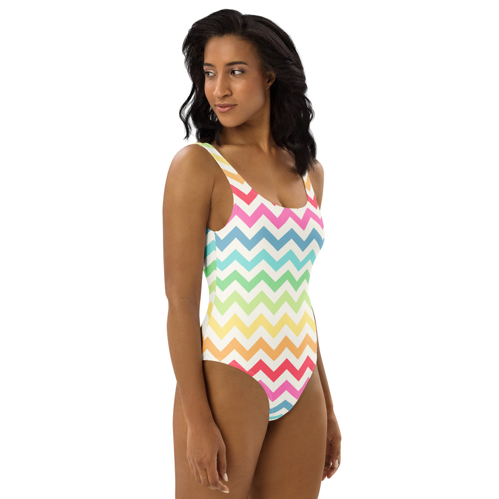 A vibrant pastel rainbow chevron one-piece swimsuit with thin straps and buttery soft fabric with UPF 50+ protection