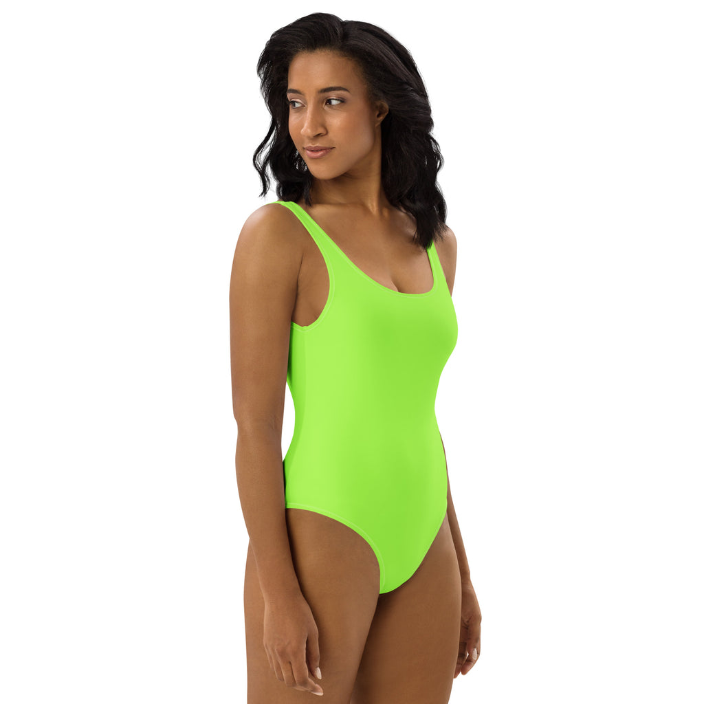 A vibrant lime green buttery soft one-piece swimsuit with thin straps and UPF 50 plus sun protection