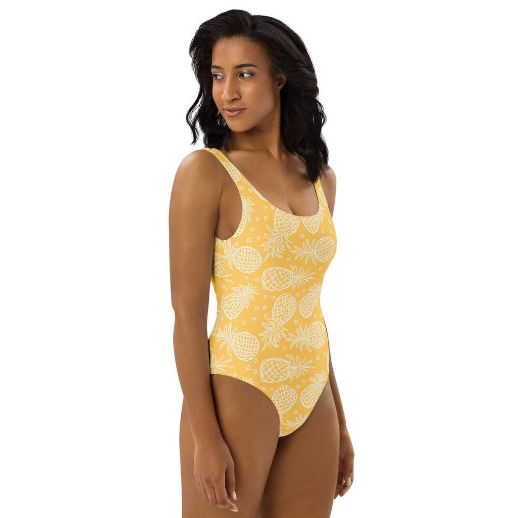 Women’s yellow pineapple one-piece buttery soft swimsuit with UPF 50 plus featuring a white pineapple pattern