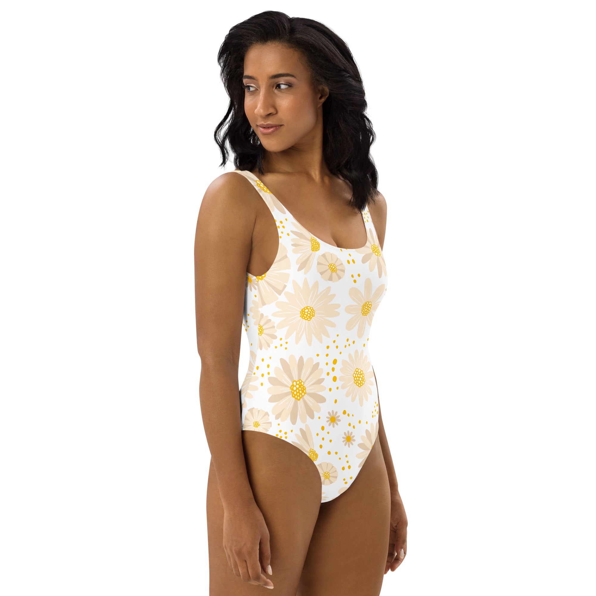 A white one-piece womens swimsuit with beige and yellow daisies buttery soft fabric and UPF 50 plus protection