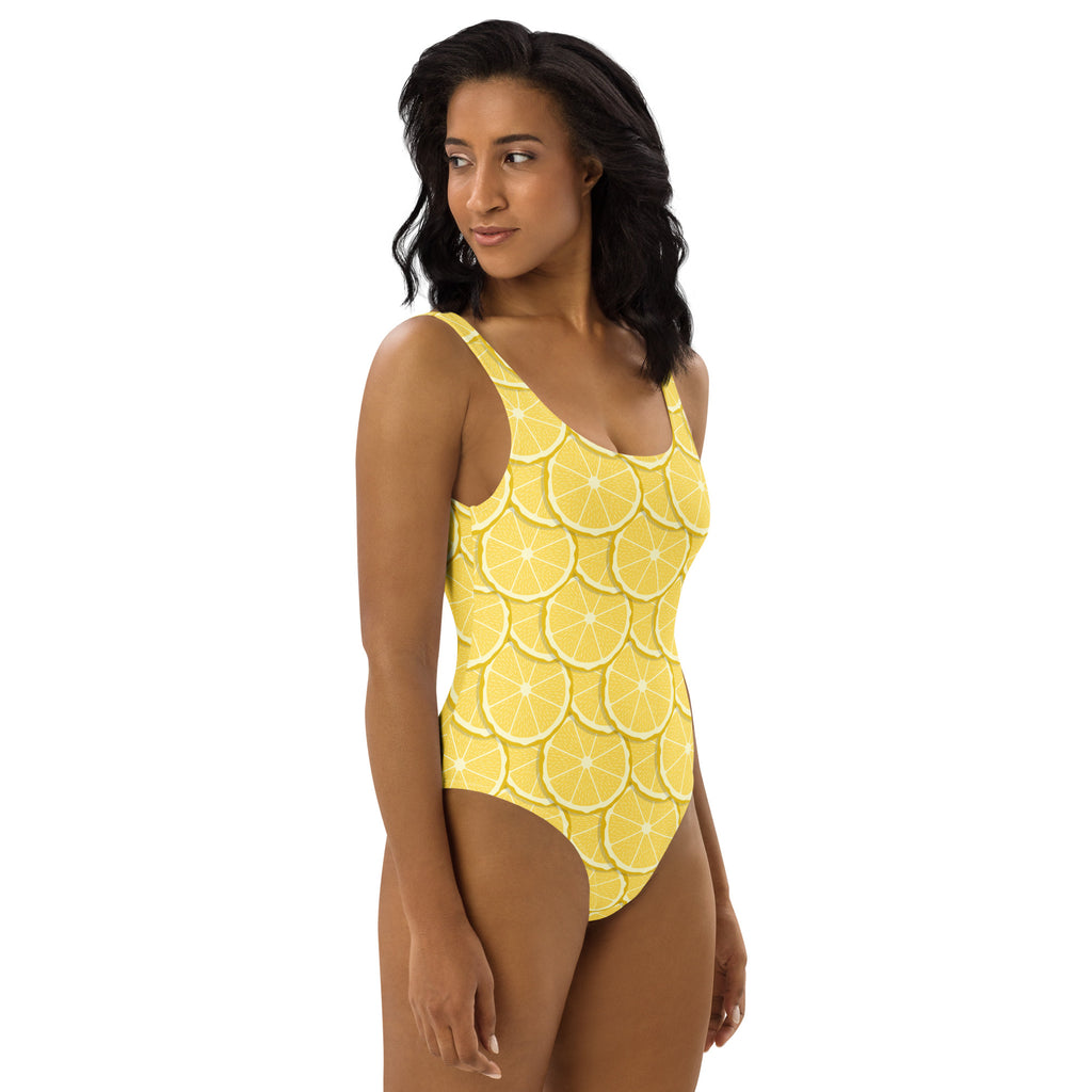 A vibrant yellow one-piece swimsuit with buttery soft fabric and lemon slice pattern offering UPF 50+ protection