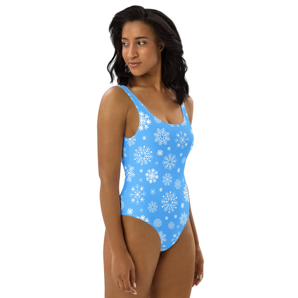 Women’s blue snowflake buttery soft one-piece swimsuit with UPF 50 plus featuring a white snowflake pattern