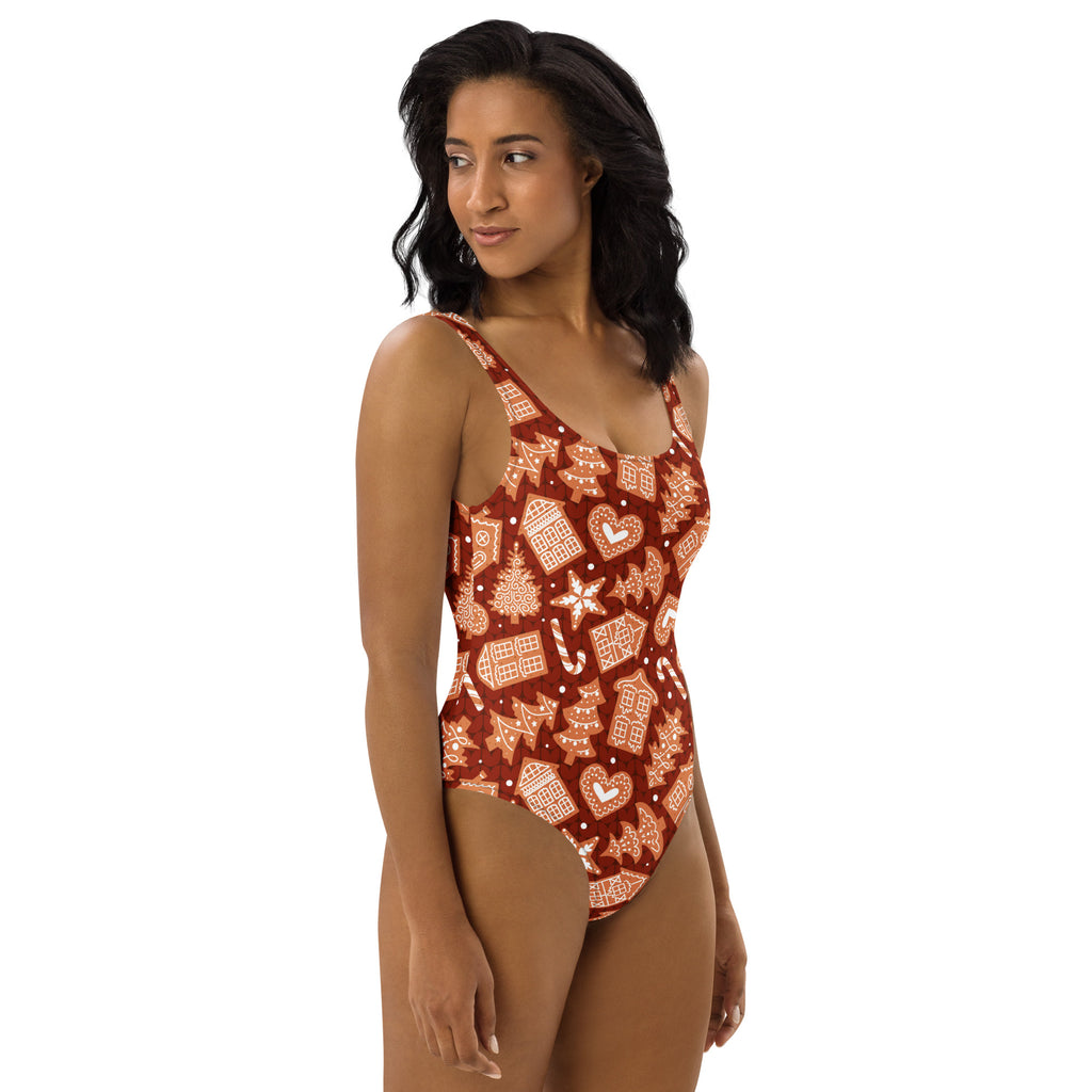 Women’s red buttery soft one-piece swimsuit with gingerbread houses candy canes snowflakes and upf 50 plus
