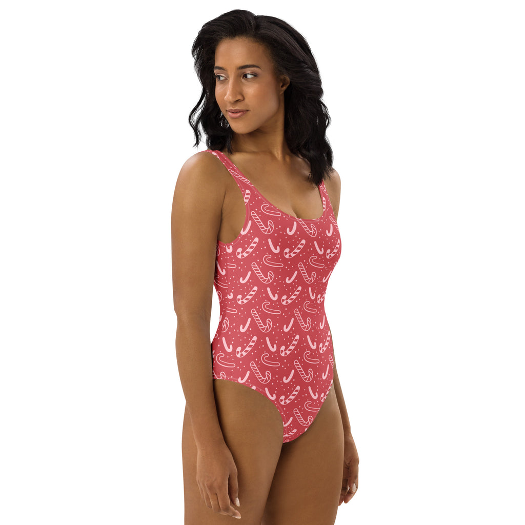 Women’s red candy cane christmas buttery soft one-piece swimsuit with upf 50 plus featuring a pink candy cane pattern