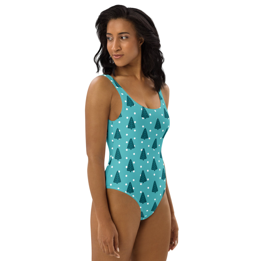 Teal women’s christmas tree buttery soft one-piece swimsuit with dark green pine trees white polka dots and UPF 50+