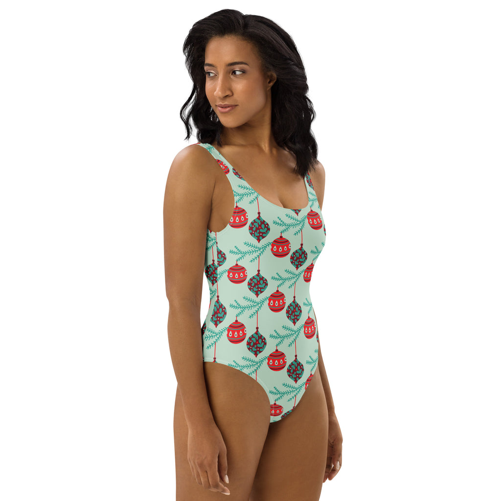 Women’s mint green buttery soft one-piece swimsuit with upf 50+ and festive red green christmas ornaments