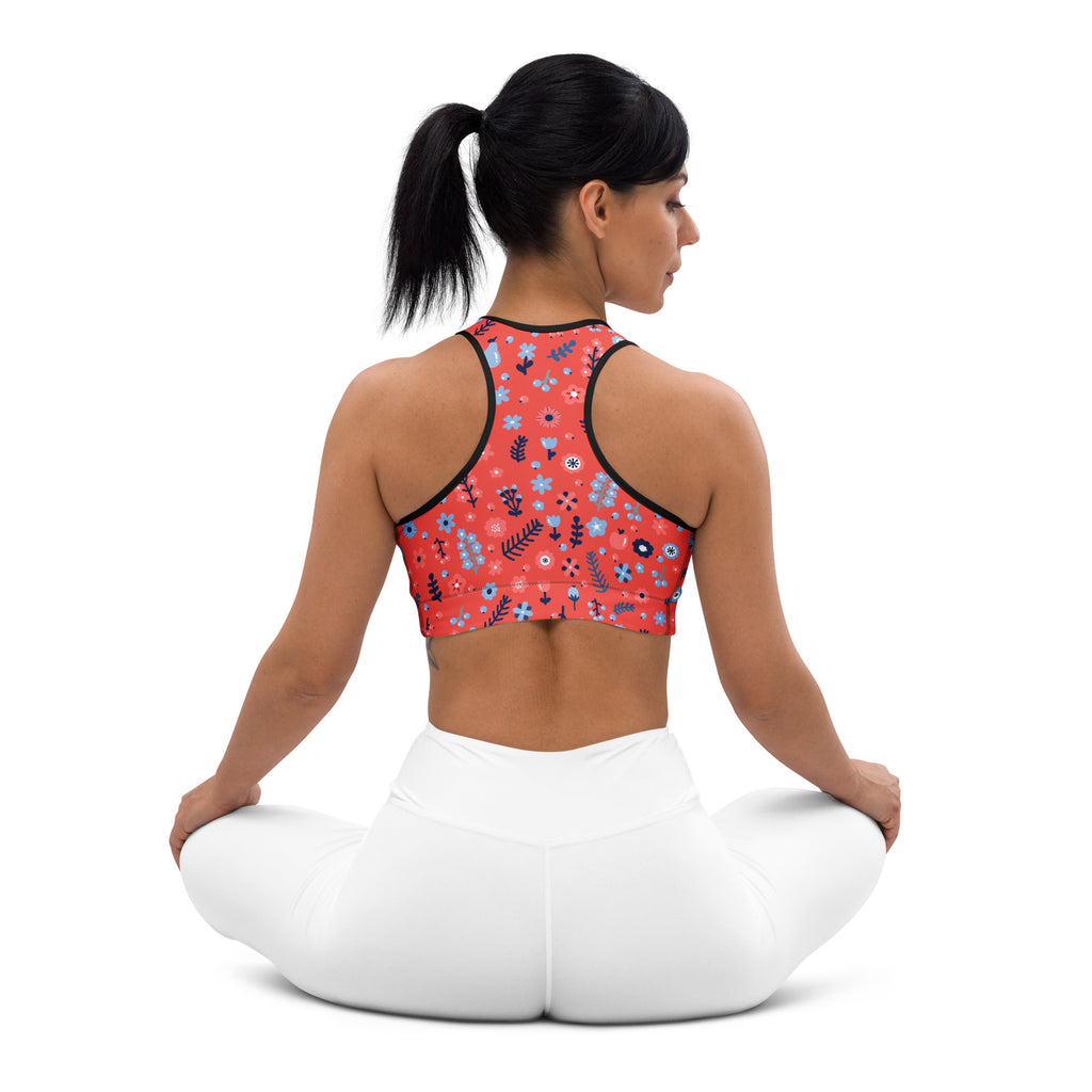 Coral-colored padded sports bra with black trim and blue white green floral pattern buttery soft and quick-dry