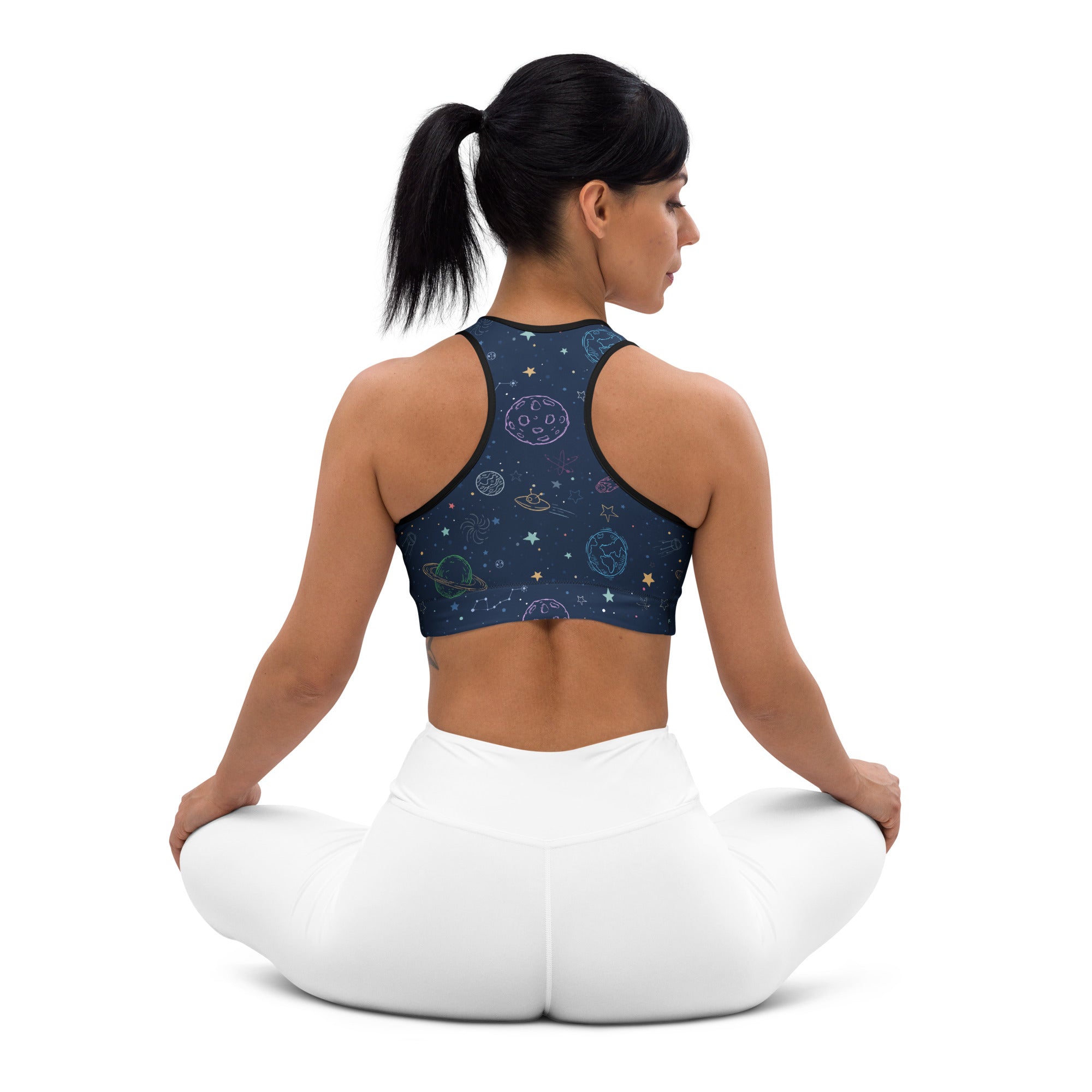 Dark blue space-themed women’s padded sports bra with celestial patterns, black trim, buttery soft and quick-dry fabric