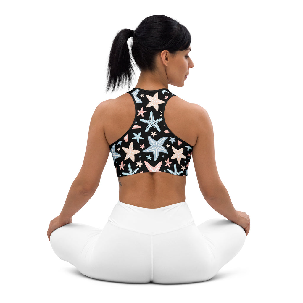 Black padded sports bra with pastel starfish print in pink blue and white buttery soft supportive quick dry design