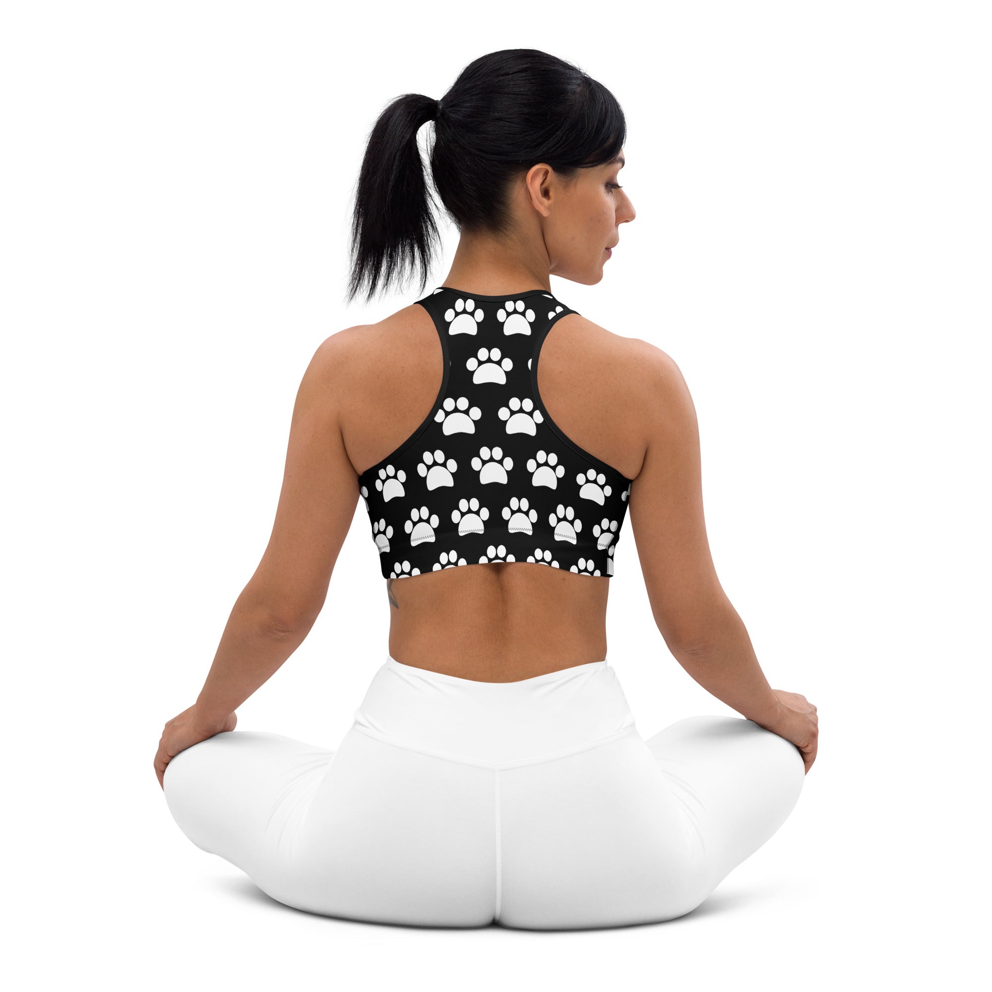 Women’s black padded sports bra with white paw print pattern buttery soft supportive and quick-dry material