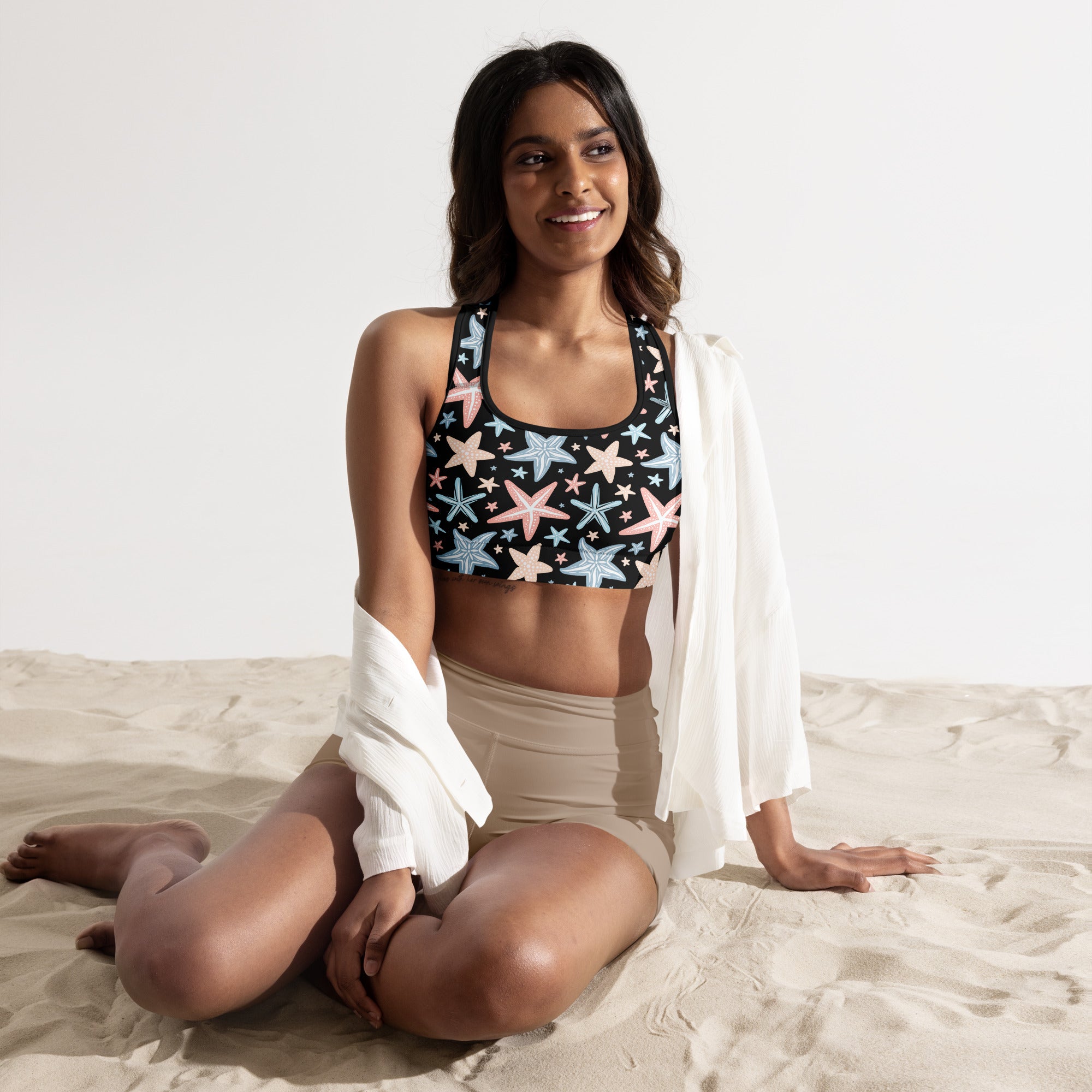Black women’s starfish print padded sports bra with pastel pink and light blue pattern, buttery soft and quick-dry