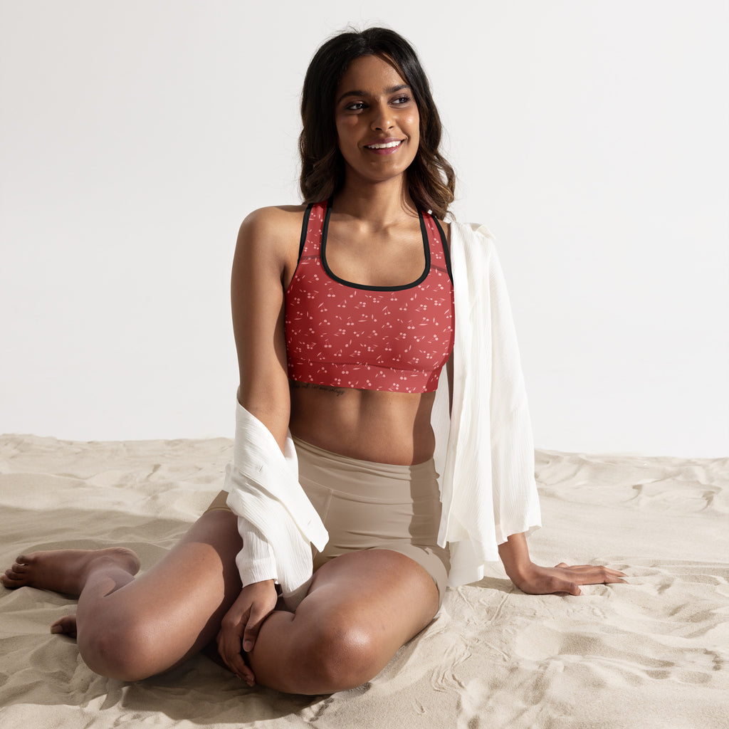 Women’s cherry print padded sports bra in red with black trim featuring a subtle pattern, buttery soft and quick-dry