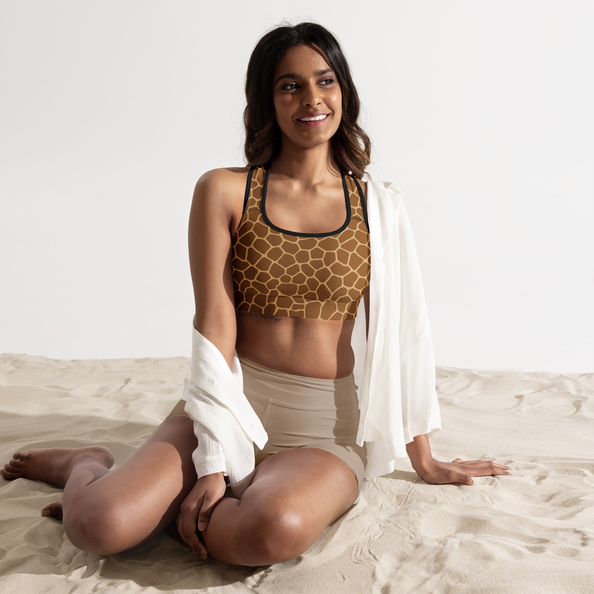 Women’s giraffe print padded sports bra with black trim, buttery soft, supportive, and quick-dry material