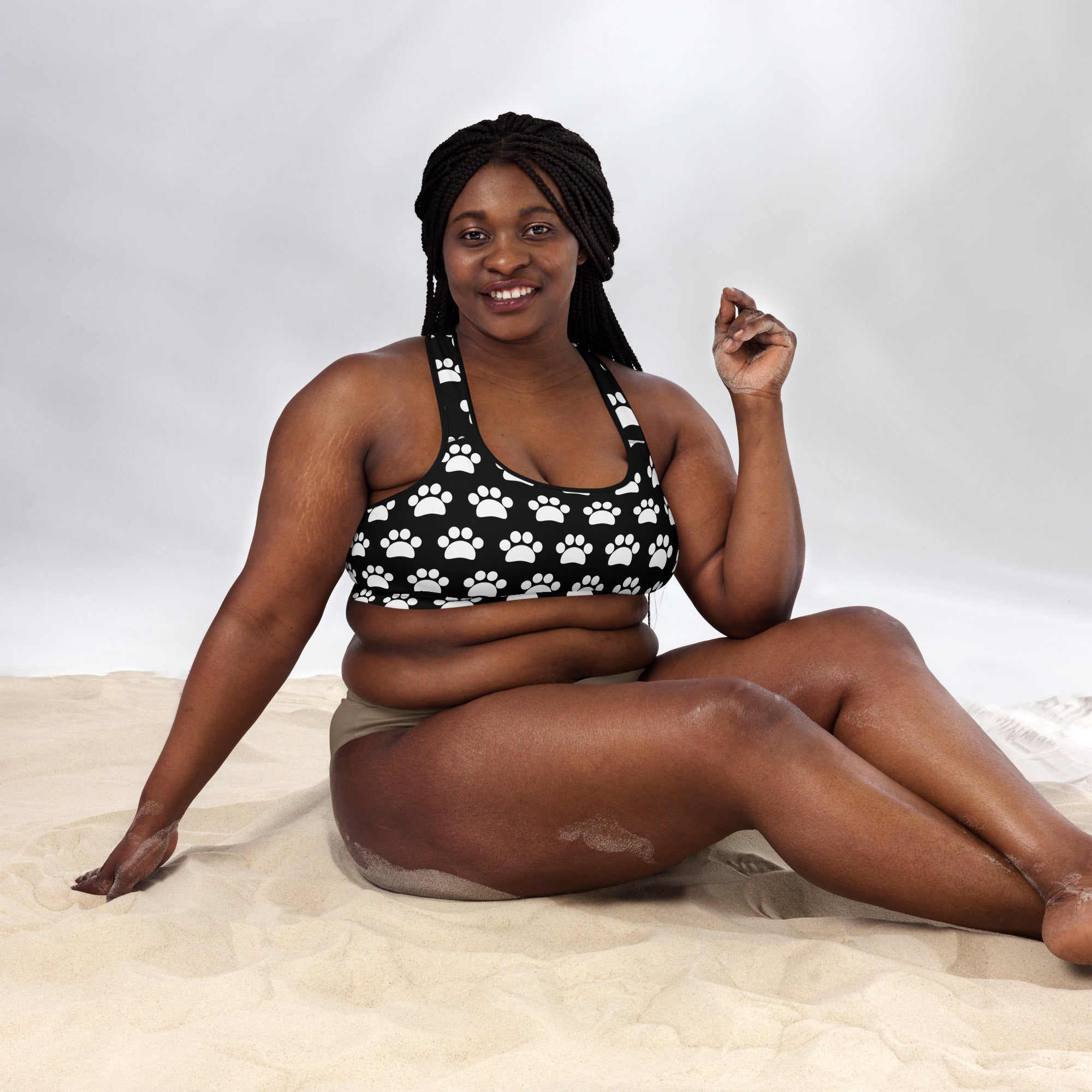 Women’s black and white paw print padded sports bra made of buttery soft, supportive, and quick-dry fabric
