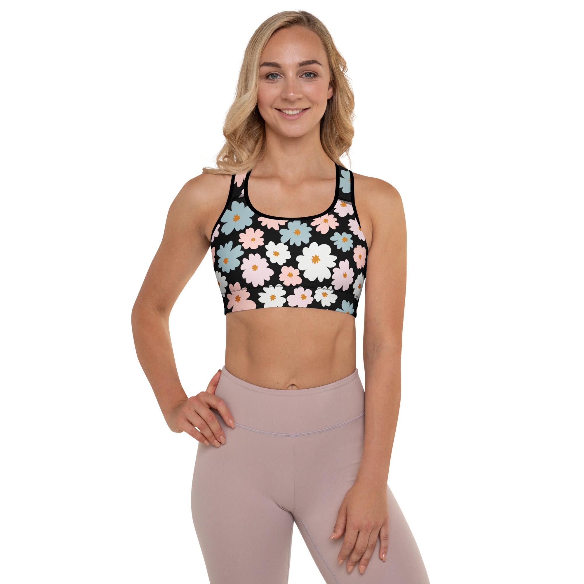 Black sports bra with vibrant white pink and blue daisies featuring retro floral padded design and quick-dry fabric