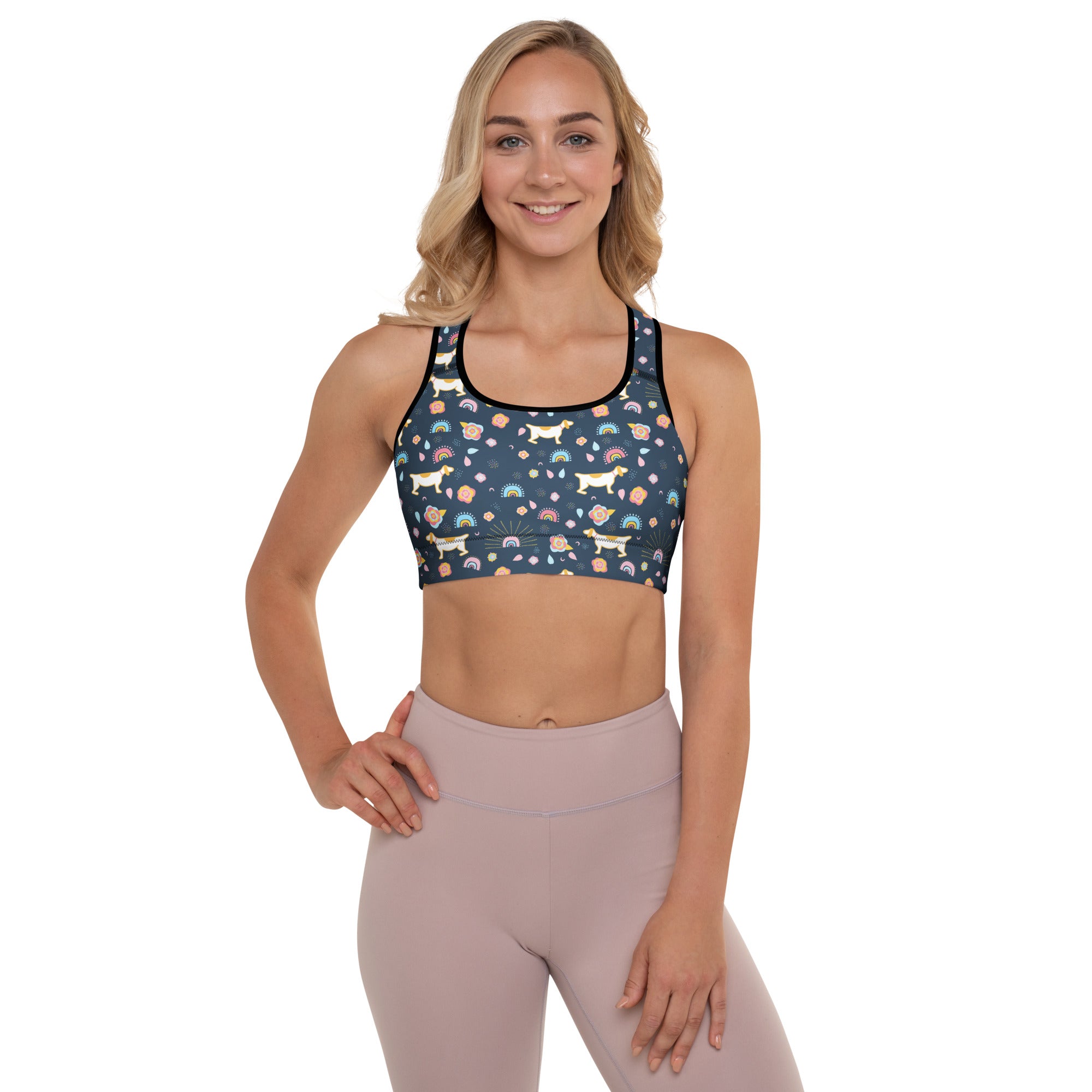 A navy blue women’s padded sports bra with white dachshunds rainbows and pastel flowers quick-dry and supportive