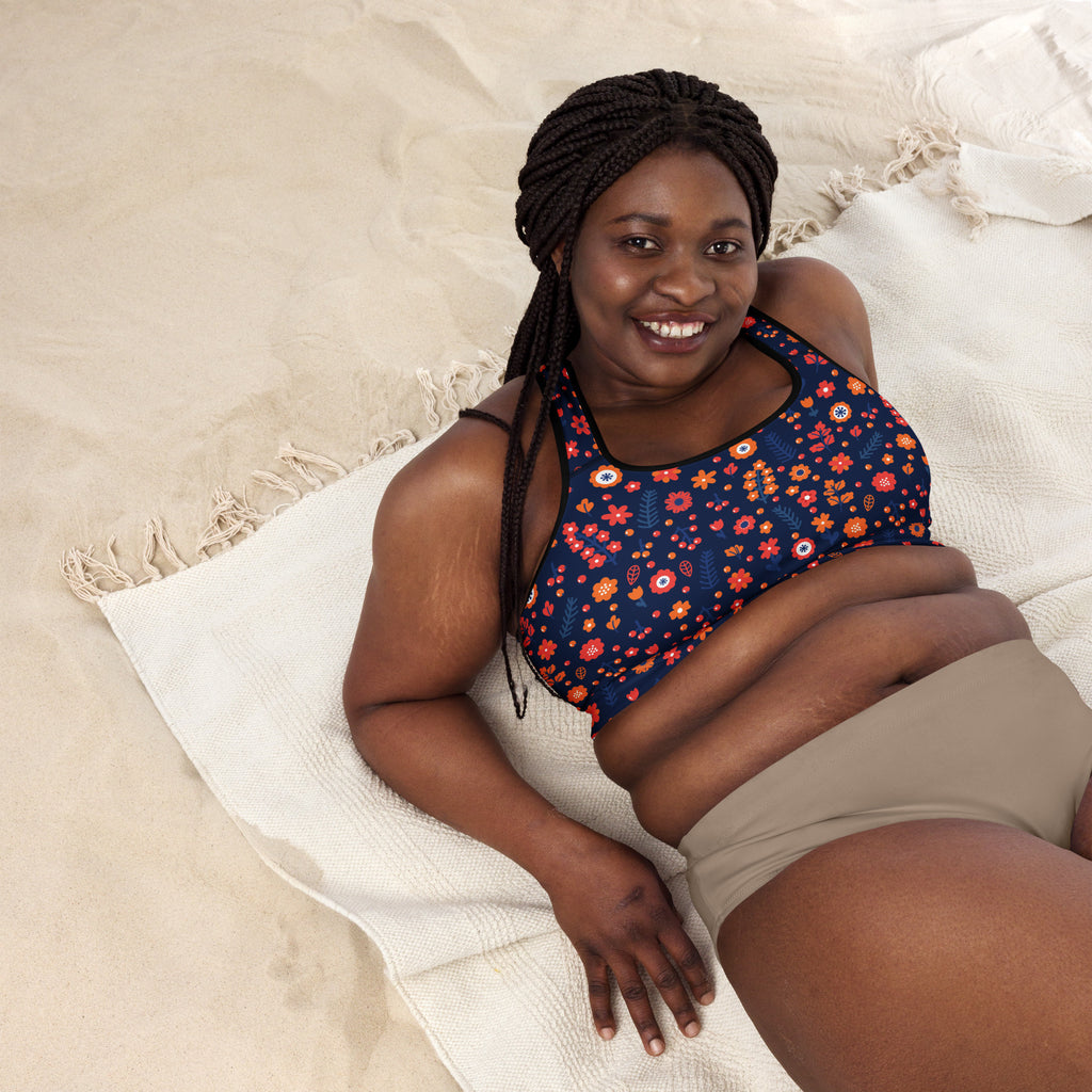 Women’s navy floral padded sports bra with vibrant orange red and white pattern buttery soft supportive and quick dry