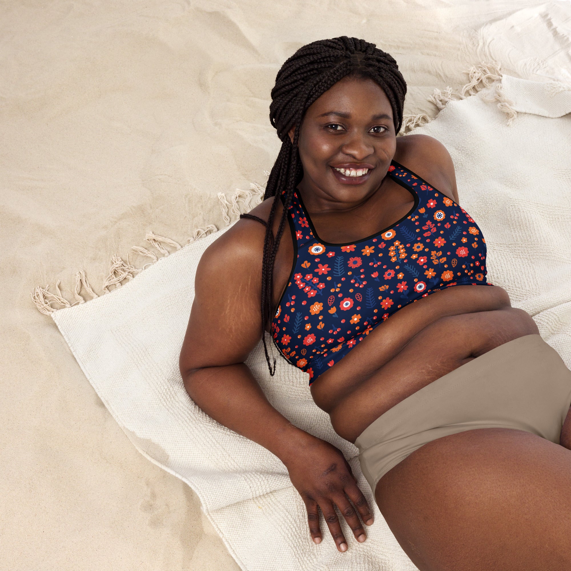 Women’s navy floral padded sports bra with vibrant orange red and white pattern buttery soft supportive and quick dry