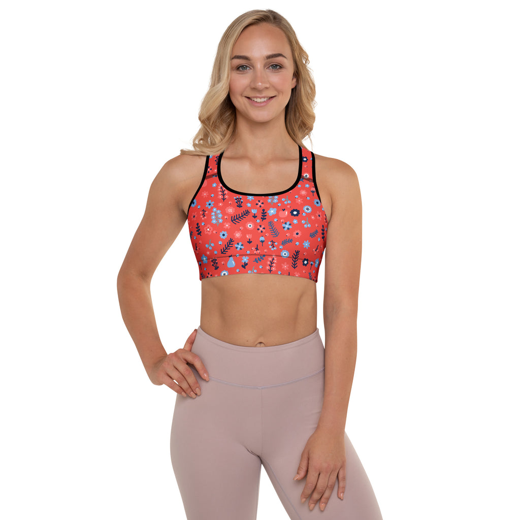 Women’s coral padded sports bra with blue and black floral pattern, black trim, buttery soft, supportive, and quick-dry