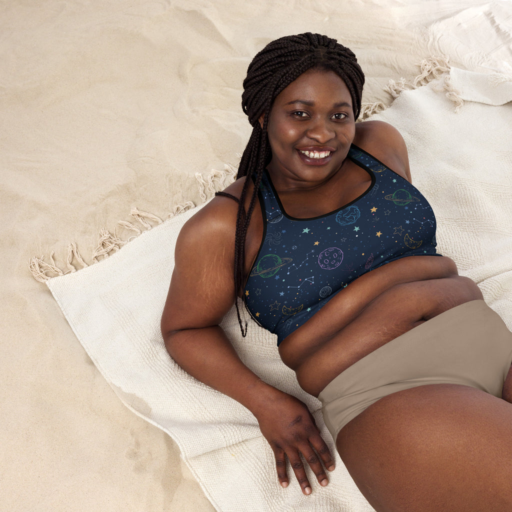 Dark blue women’s padded sports bra with celestial planets and stars pattern, buttery soft, supportive, and quick dry