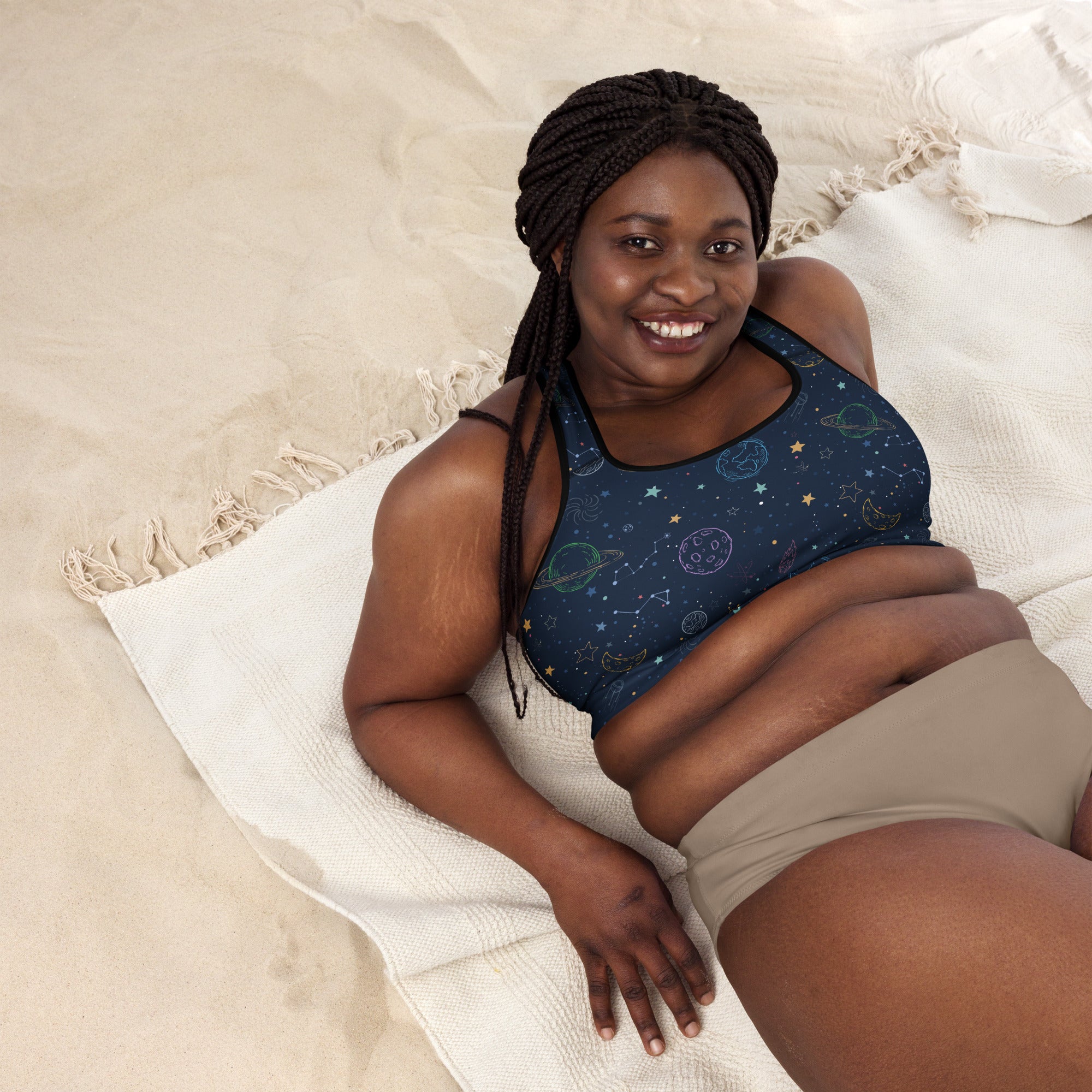 Dark blue women’s padded sports bra with celestial planets and stars pattern, buttery soft, supportive, and quick dry