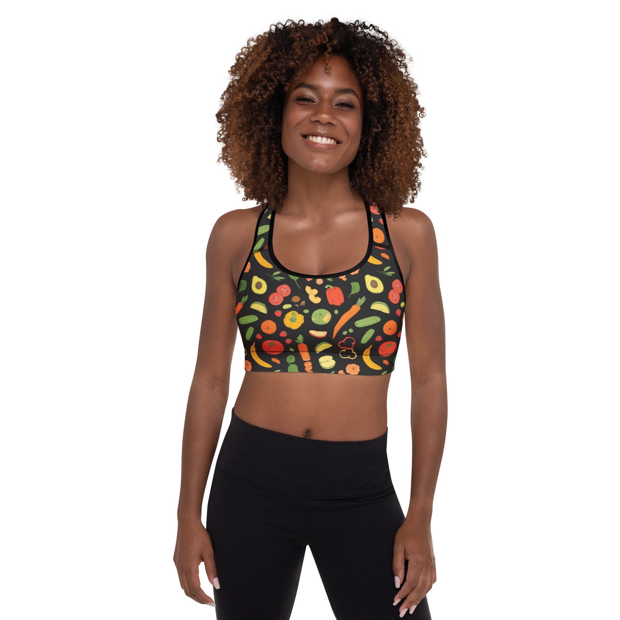 A vibrant dark green women’s padded sports bra with colorful fruit and vegetable print, buttery soft and quick dry