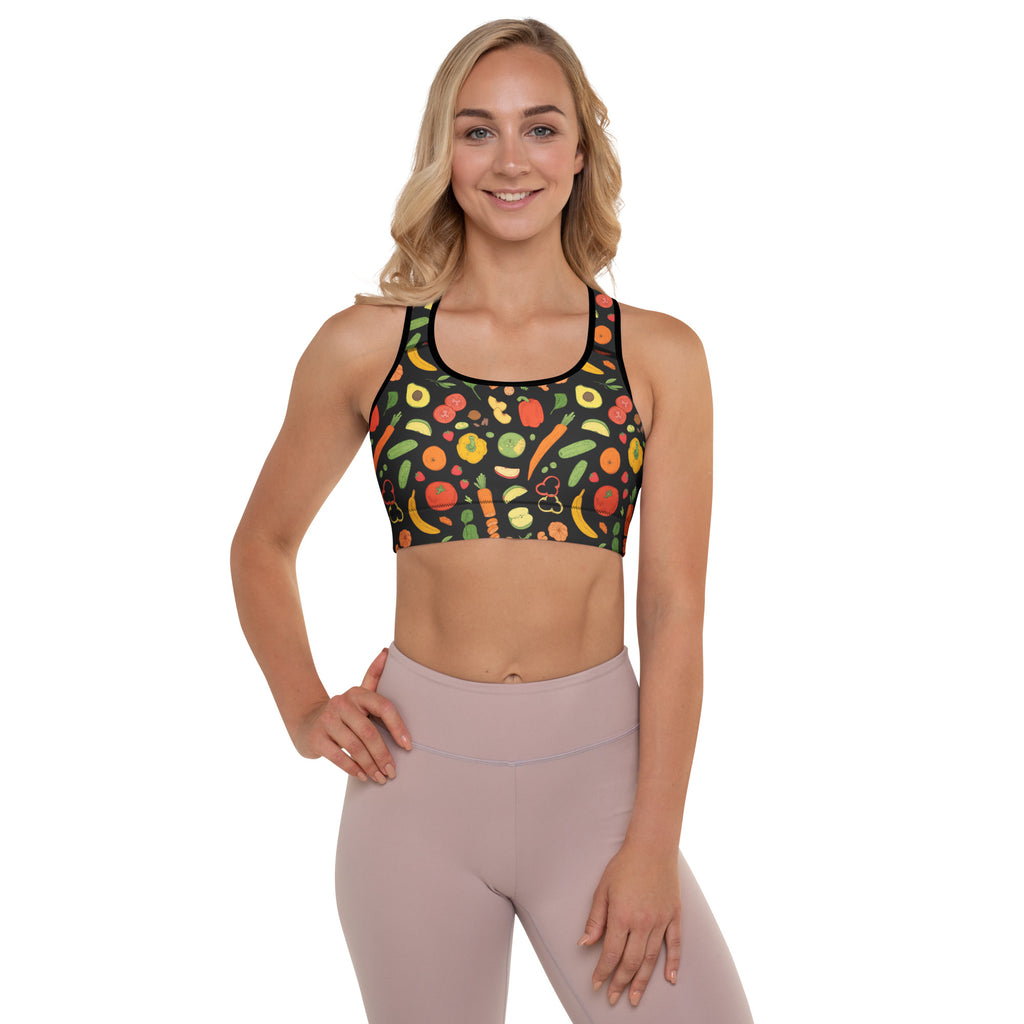 A vibrant black padded sports bra with colorful fruit and vegetable print, buttery soft, supportive, and quick-dry