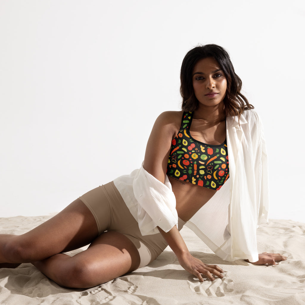 A vibrant green womens padded sports bra with colorful fruit and vegetable print buttery soft and quick dry