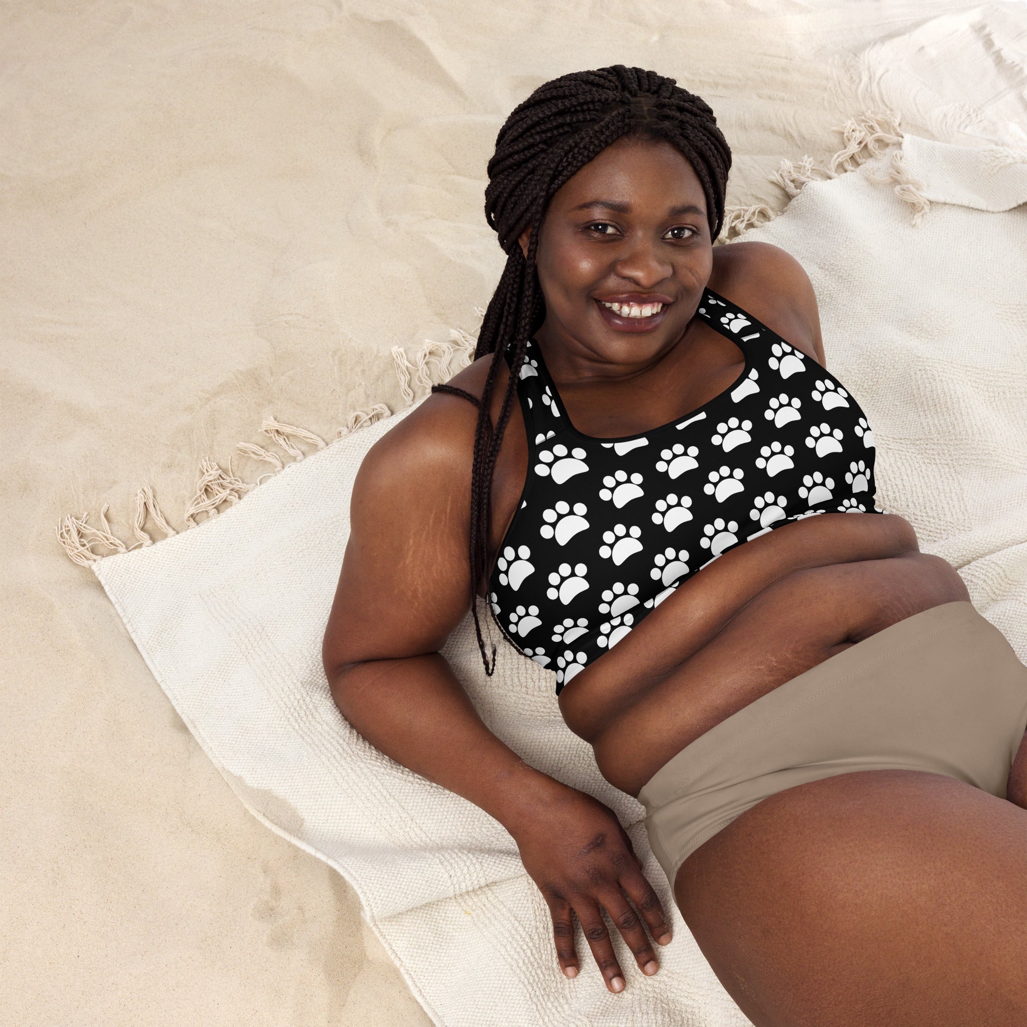 Women’s black and white paw print padded sports bra made of buttery soft quick-dry fabric for supportive comfort