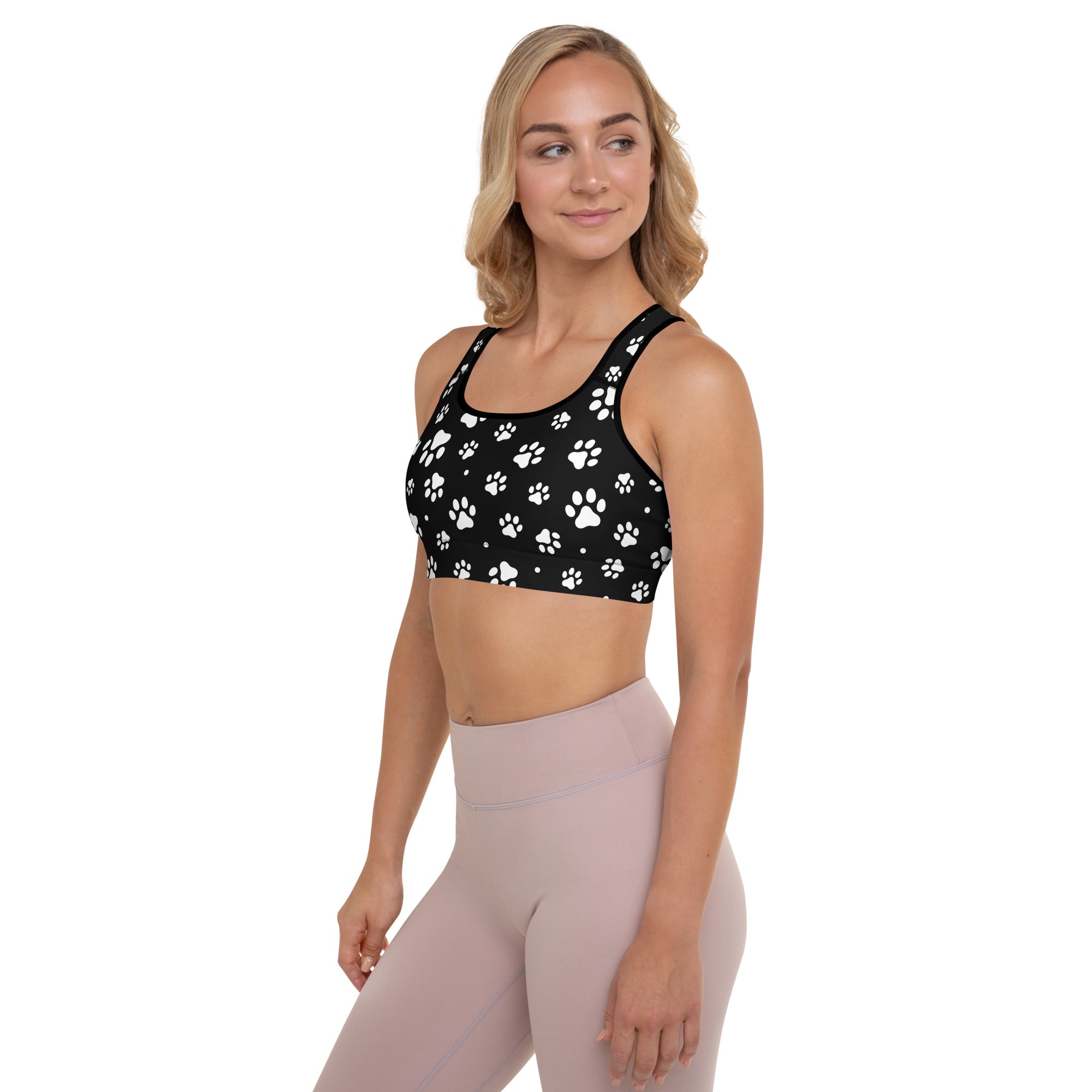 Black women’s padded sports bra with white paw print pattern buttery soft supportive and quick-dry fabric