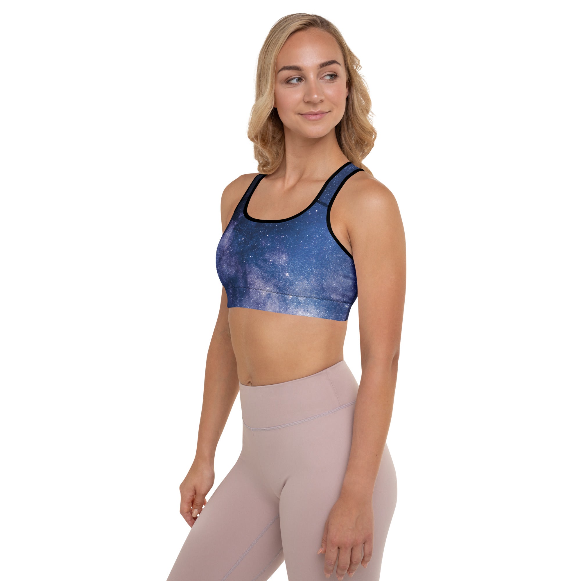 Blue galaxy print padded sports bra with black trim made of buttery soft supportive quick dry fabric for women