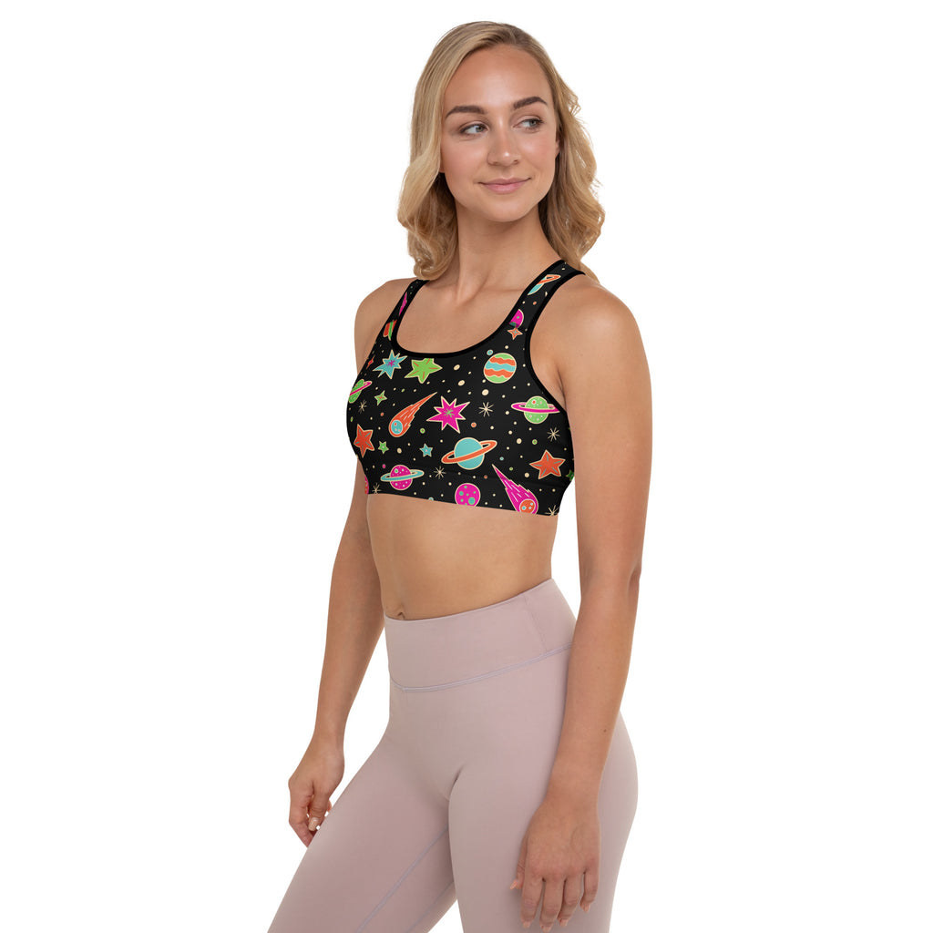 Women’s retro space padded sports bra in black with vibrant cosmic neon planets stars and comets design quick-dry