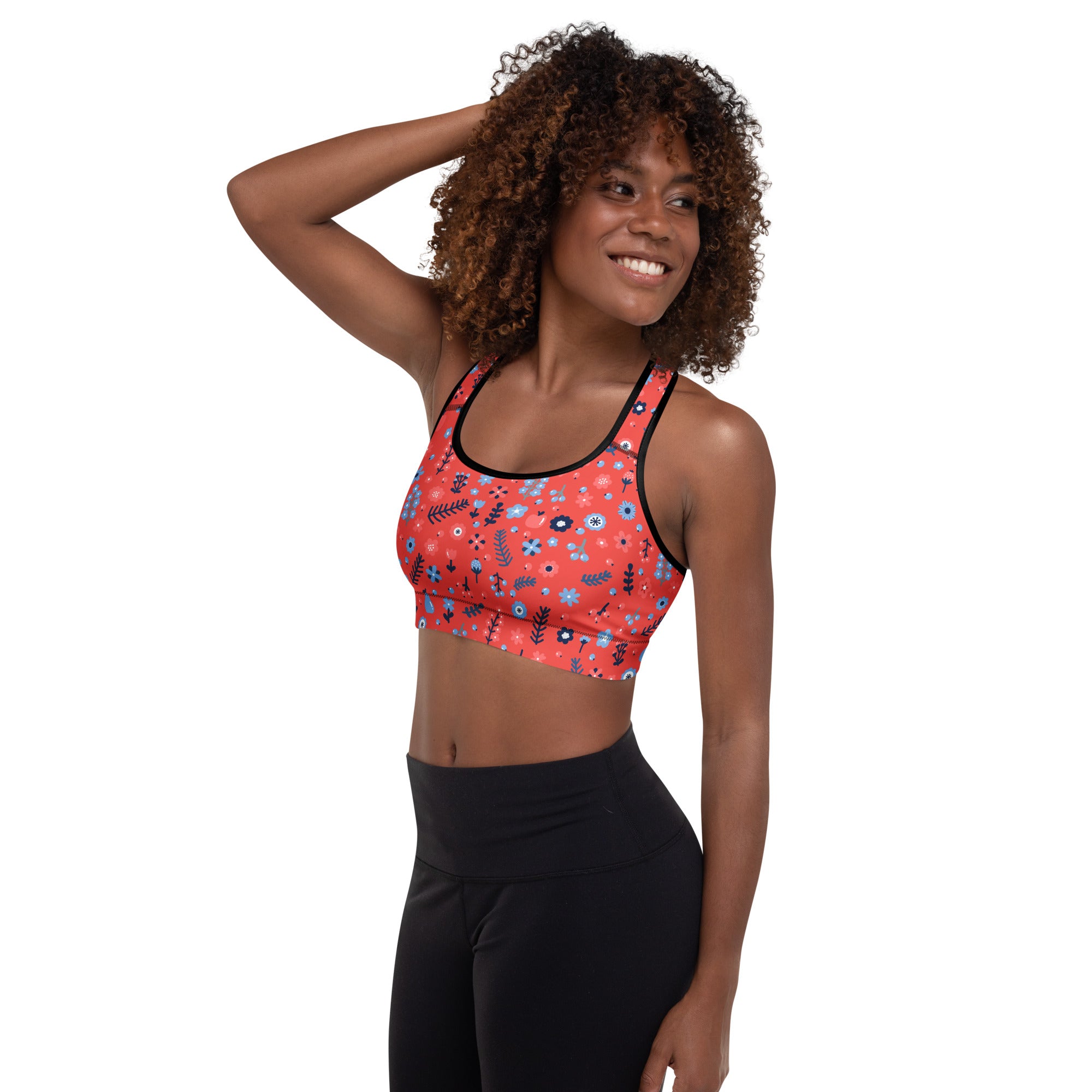 Women’s coral sports bra with black trim and blue floral pattern buttery soft supportive quick-dry material