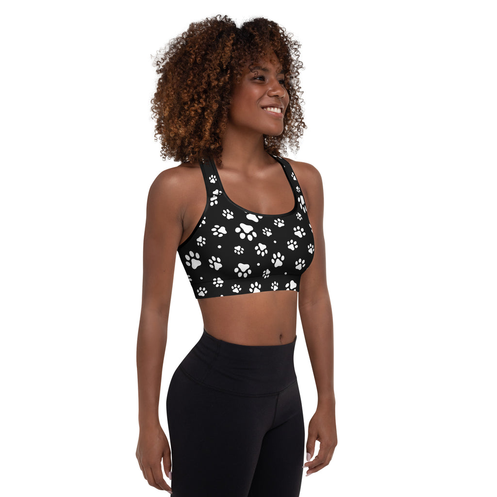 Black women’s padded sports bra with white paw print pattern buttery soft supportive and quick-dry fabric